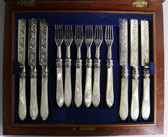 A cased set of twelve pairs of mother of pearl handled silver dessert eaters, James Collins, Birmingham, 1857.